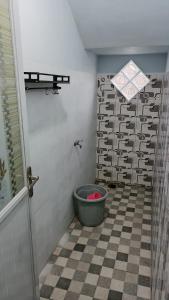 a bathroom with a bucket in the corner of a room at Villa Kanaya in Sukapura +17 photos