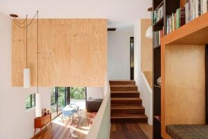 a staircase in a house with a stair case at Blackpool House - Stay Waiheke in Oneroa