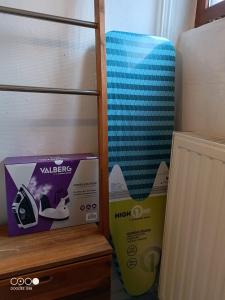 a room with a box and a suitcase on a shelf at Maison Bressanne in Sornay +8 photos