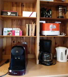 a coffeemaker and a coffee maker on a shelf at Maison Bressanne in Sornay