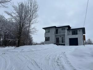 a house sitting on top of a pile of snow at Villa Bory in Vygoda