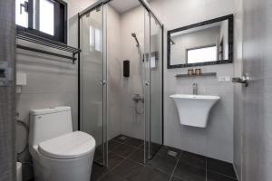 a bathroom with a shower and a toilet and a sink at IsShoNi B&B in Huxi +14 photos