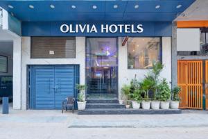a store front of a hotel with a blue door at Olivia Hotels - Delhi Airport in New Delhi