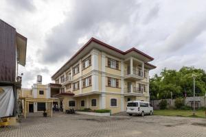 a white van parked in front of a building at Metro Vigan Inn MAIN in San Vincente