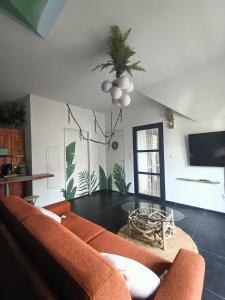 a living room with a couch and a table at La Cabane du lagon atypique et accès à la plage in La Saline les Bains