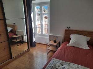 a bedroom with a bed and a large mirror at Ecrin de Valdeblore in Valdeblore