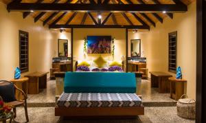 a living room with a blue couch in the middle at Taveuni Dive Resort in Waiyevo