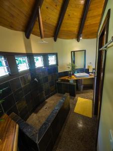 a large bathroom with a tub and a sink at Taveuni Dive Resort in Waiyevo