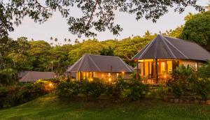 a house with lights in the yard at Taveuni Dive Resort in Waiyevo