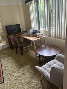 a living room with a desk with a computer and a couch at Dalby home in Dalby
