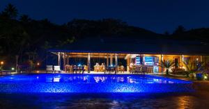 a house with a swimming pool at night at Taveuni Dive Resort in Waiyevo