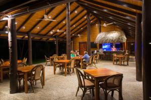 a group of people sitting at tables in a restaurant at Taveuni Dive Resort in Waiyevo