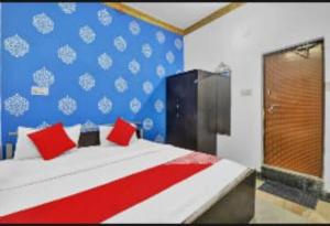 a bedroom with a large bed with red pillows at RROOMS Eco Hotel Best in Lucknow