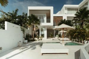 an exterior view of a house with a swimming pool at The Iggy Villa 2BR in Cemagi