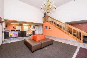 a lobby with a chair and a staircase in a building at Motel 6-Waterloo, IA in Waterloo