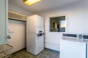 a kitchen with a white refrigerator and a sink at Motel 6-Moses Lake, WA in Moses Lake