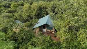 an aerial view of a house with a blue roof at Hemingway's Luxury Tented Camp in Paraa