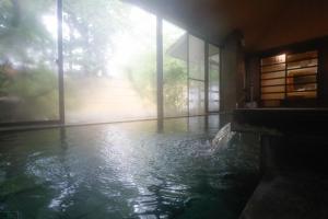 a pool of water in a room with a window at Fuji Yamanakako Hotel in Yamanakako