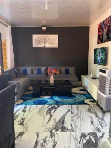 a living room with a couch and a table at Ramachi Apartment A in Livingstone