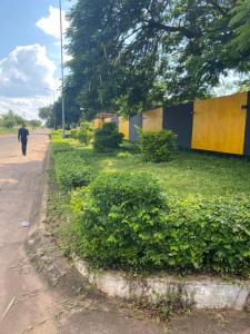 a person walking down a street next to a building at Ramachi Apartment A in Livingstone