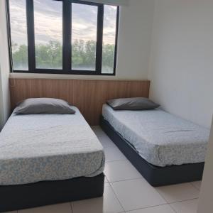 two beds in a room with two windows at I&M Staycation in Alor Setar +17 photos