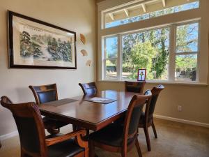 a dining room with a wooden table and chairs at Amitabha Wine Country Cottage in Santa Rosa