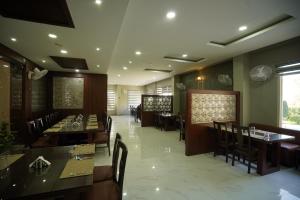 a dining room with tables and chairs in a restaurant at Mount Valley Resort in Kumbhalgarh