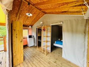a room with a tent and a bed in it at Camping L'Amandier in Gigors