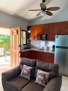 a living room with a couch and a kitchen at Happy Oasis Second Floor Condo with Terrace in Coco