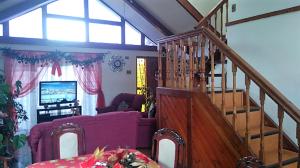 a living room with a staircase and a living room with a couch at Casa Plaza Los Caballos in Olmué
