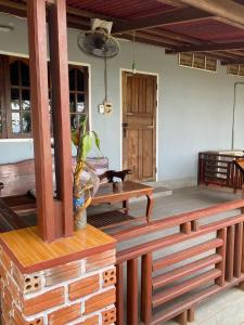 a room with wooden benches and a table at Anouxa Riverview Guesthouse in Champasak +150 photos