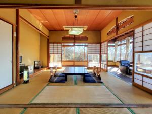 a large room with a table and chairs in it at 偕楽園 in Shirasaka