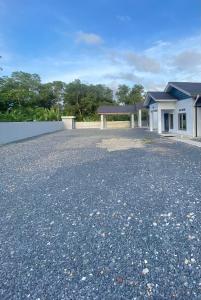 an empty driveway in front of a house at Homestay Babah in Jitra