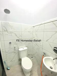 a bathroom with a toilet and a sink at Homestay Babah in Jitra +4 photos
