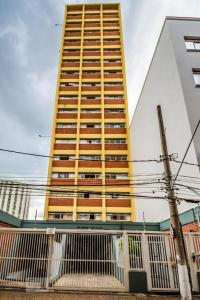 a tall building with a fence in front of it at Barreto Leme Studio 12 in Campinas