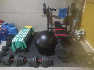 a room with a gym with weights and a ball at Koa's Beach House in Tangalan