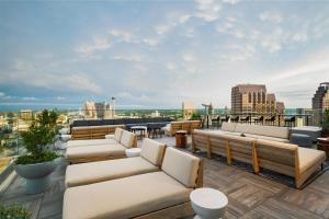 a rooftop patio with couches and tables on a building at Thompson San Antonio - Riverwalk, by Hyatt in San Antonio