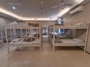 a room with four bunk beds in a room at Sarju Palace Dormetry in Valsād