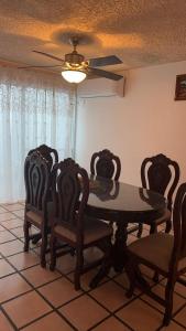 a dining room with a table and chairs and a ceiling fan at Not for rent in Mazatlán +2 photos