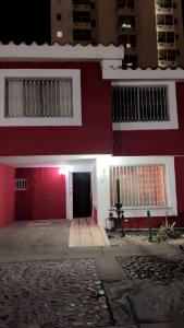 a red and white building with a door and a doorway at Not for rent in Mazatlán
