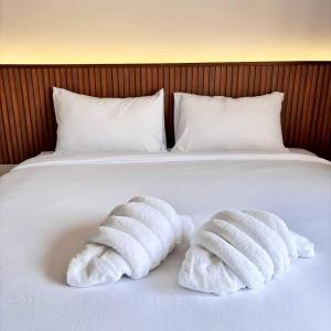 two towels are sitting on top of a bed at Ma Relax Place in Ban Hau Chang