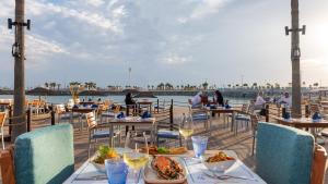 a restaurant with tables and chairs with a view of the water at InterContinental Abu Dhabi by IHG in Abu Dhabi