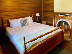 a bedroom with a bed with a wooden headboard at Stone Walls in Derby +16 photos