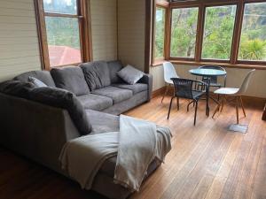 a living room with a couch and a table at Stone Walls in Derby