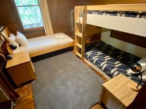 a small room with two bunk beds and a window at Stone Walls in Derby