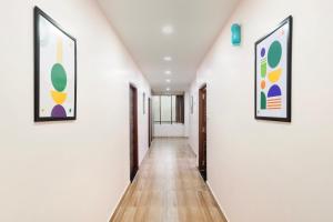a hallway with two framed art on the walls at Treebo Sri Krishna Palace in Bhubaneshwar