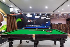 a billiard room with a green pool table at Treebo Sri Krishna Palace in Bhubaneshwar +36 photos