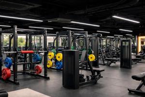 a gym with a lot of equipment in it at Rose & Golf at Rose Apple Square in Siem Reap