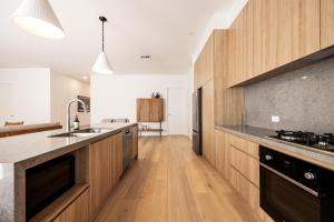 a kitchen with wooden cabinets and a counter top at Shining House Villa A in Tanunda