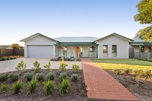 a house with a brick walkway in front of it at Shining House Villa A in Tanunda